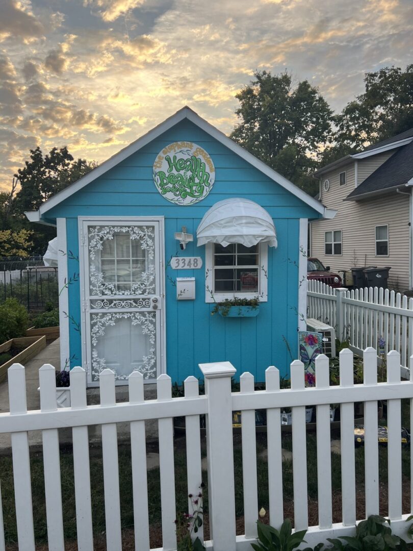 A blue and white house with a picket fence