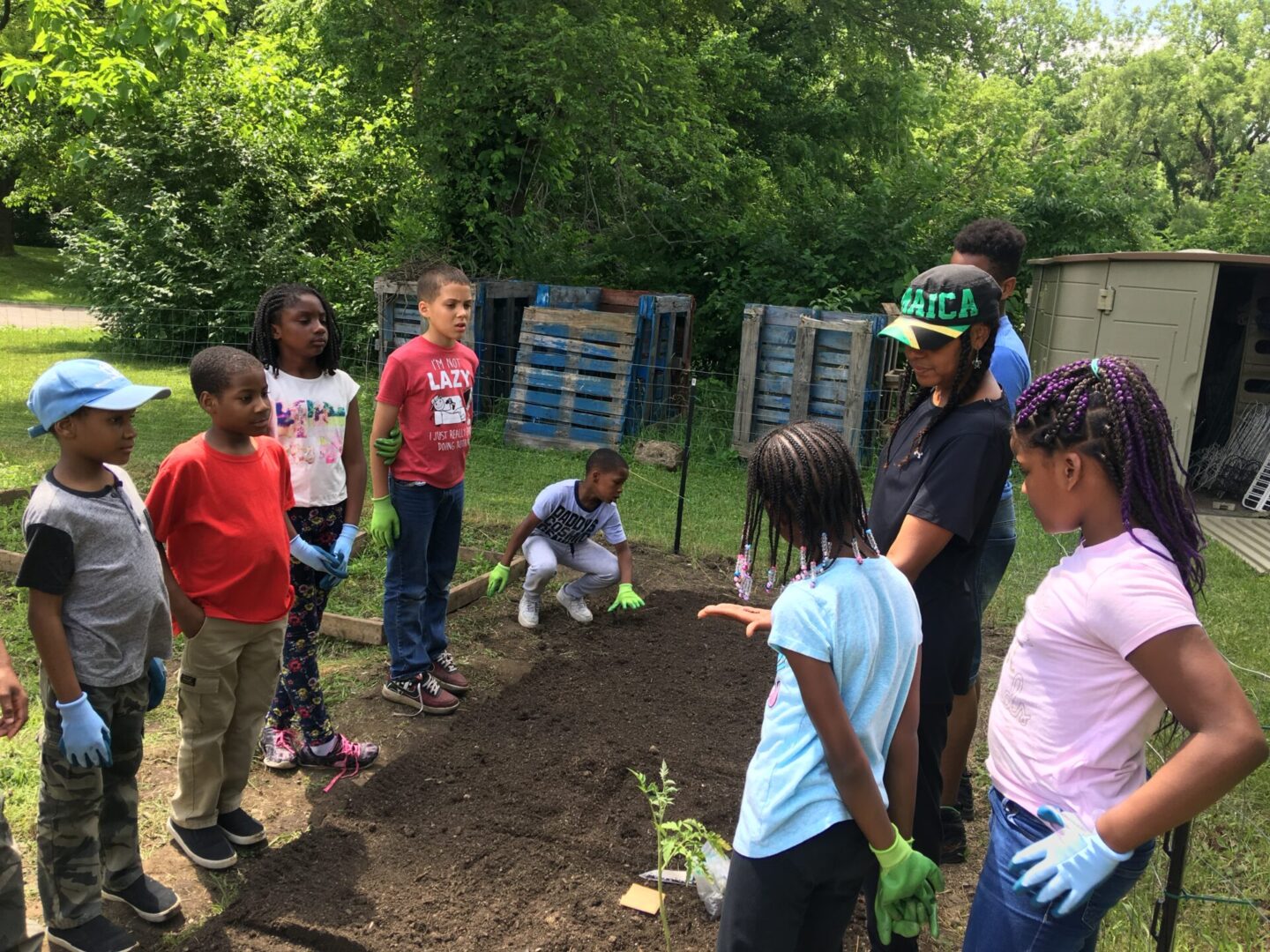 A group of people standing around in the dirt.